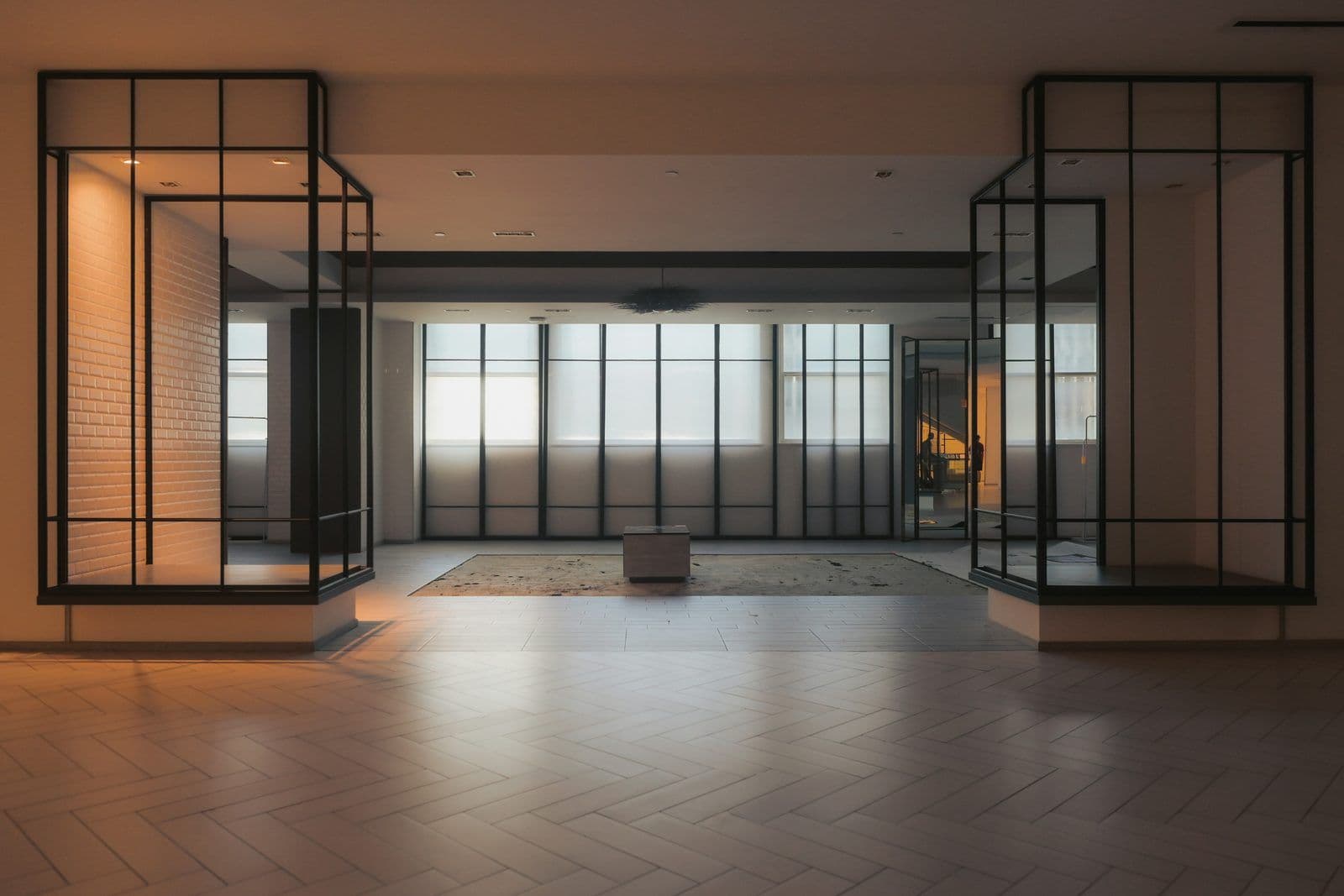 Glass partitions with black frames in an office corridor